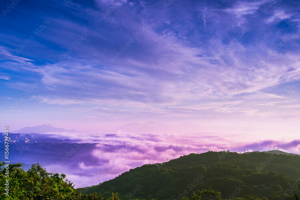 Fototapeta premium Description: A serene morning unfolds over the mountains of Shulin District New Taipei City Taiwan, with a soft pink and purple sky above a blanket of rolling clouds and distant city silhouettes.