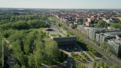 Drone video zooming in on the Museum of Ethnography during sunrise, highlighting the curved architecture with City Park and Puskás Aréna softly visible in the background.  