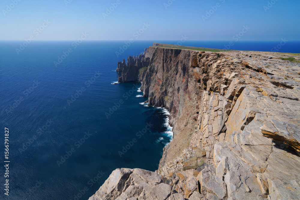 Dramatic Coastal Cliffs: Ocean View, Rugged Texture, Sunny Day, Serene Mood, High-Angle Shot. Dramatic Coastal Cliffs: Ocean View, Rugged Texture, Sunny Day, Serene Mood, High-Angle Shot.