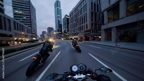 Bikers riding through city streets at dawn