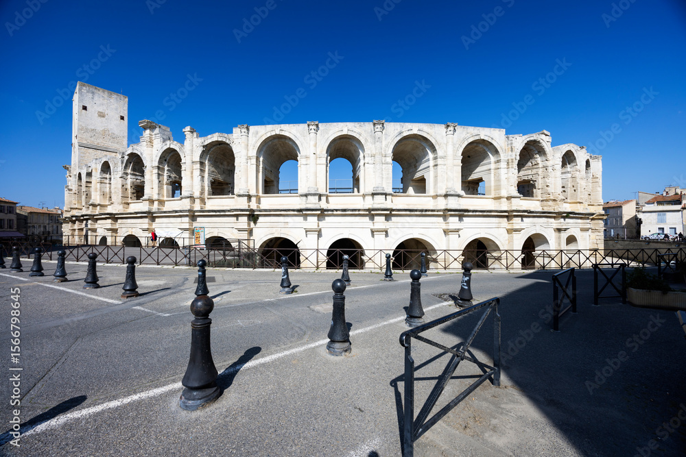Fototapeta premium Arles Arena showing its arches in Provence, France, under blue sky