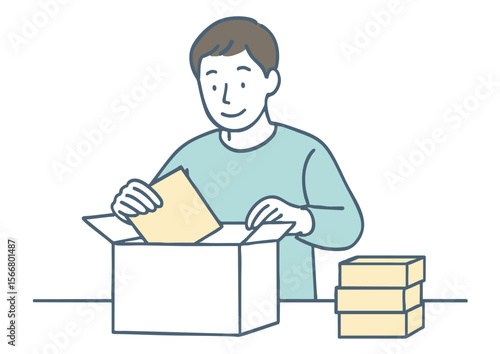 段ボールに商品を詰める男性（フリマアプリ・物販イメージ）
