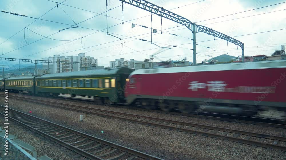 Touring the Green Train as it Passes Through Urban Landscape on a Cloudy Day Touring the Green Train as it Passes Through Urban Landscape on a Cloudy Day