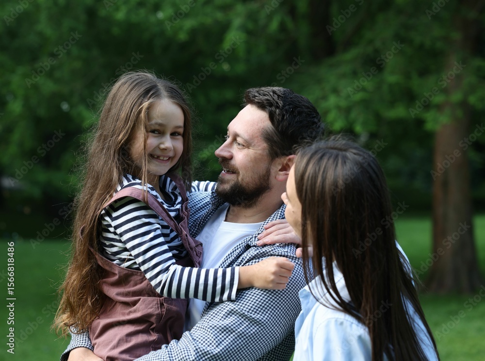 Happy parents and their daughter in park Happy parents and their daughter in park