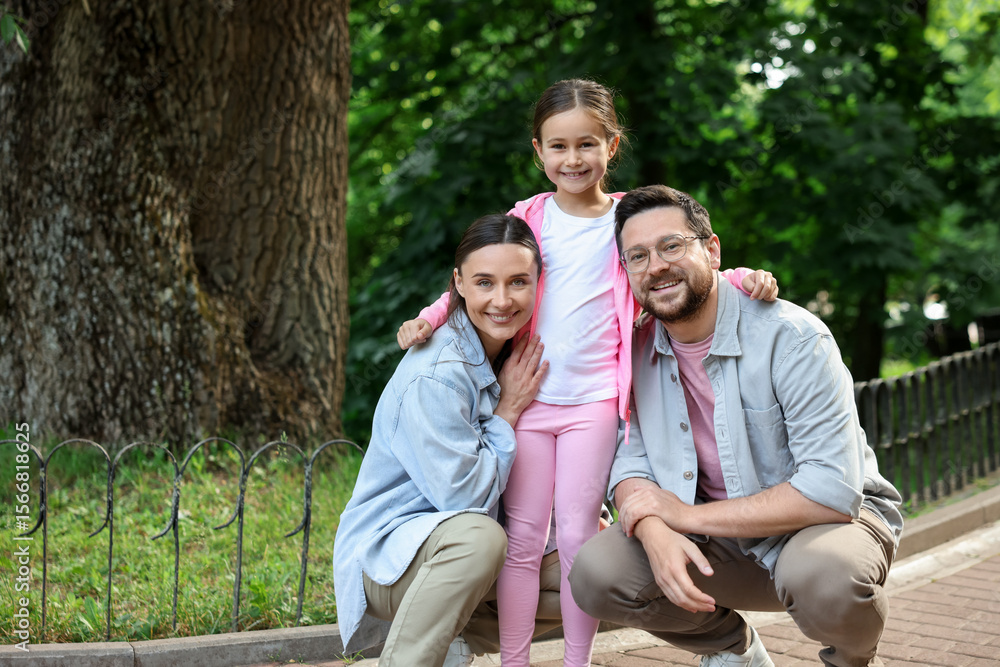 Happy family spending time together in park Happy family spending time together in park