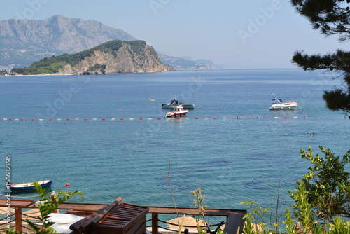 Wallpaper Mural Picturesque Mogren Beach in Budva, Montenegro, with Sunbeds, Umbrellas, and Sveti Nikola Island View Torontodigital.ca
