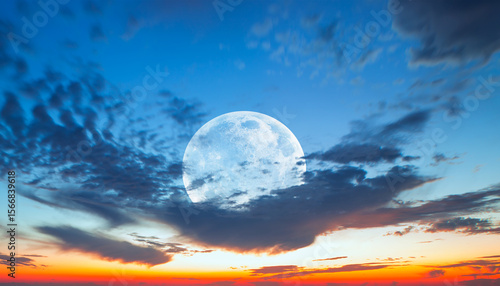 Fototapeta Naklejka Na Ścianę i Meble -  Night sky with full moon in the dark clouds and darkblue sea in the foreground 