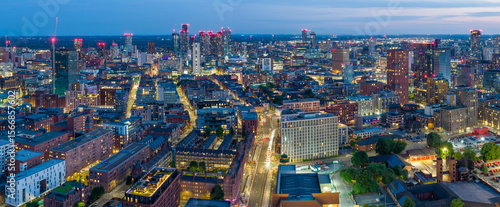 Panoramic night view of the illuminated skyline of Manchester UK.