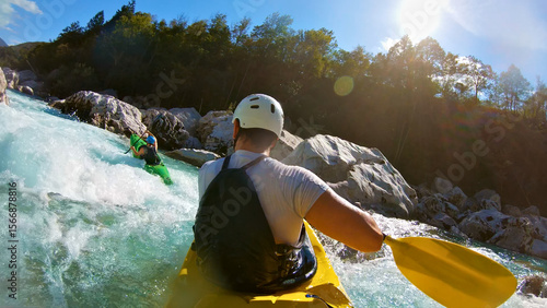 Bild auf Leinwand Two kayakers navigate churning rapids in a wild river, paddles slicing through frothy water, capturing the thrill and raw power of whitewater kayaking