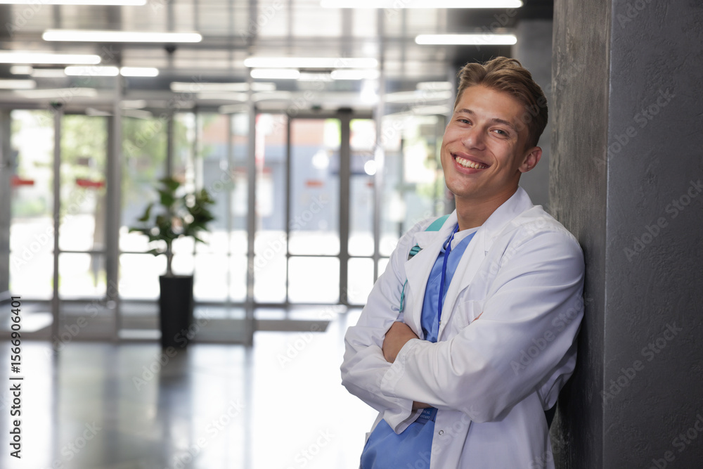 Medical student in uniform with backpack indoors, space for text Medical student in uniform with backpack indoors, space for text