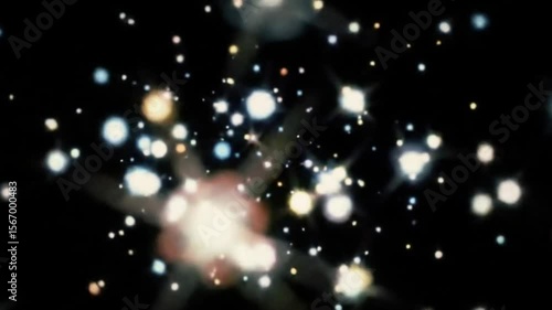 Abstract sparkling light particles dance and shimmer on a black background
