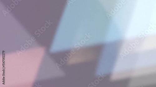 Abstract pastel triangles create a soft, dreamy background texture