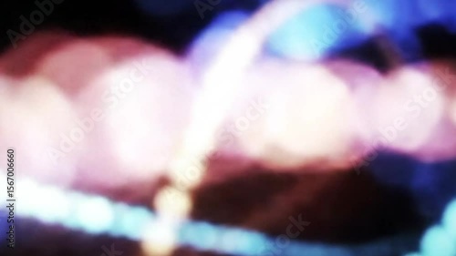 Abstract light trails create a dynamic, colorful bokeh background pattern