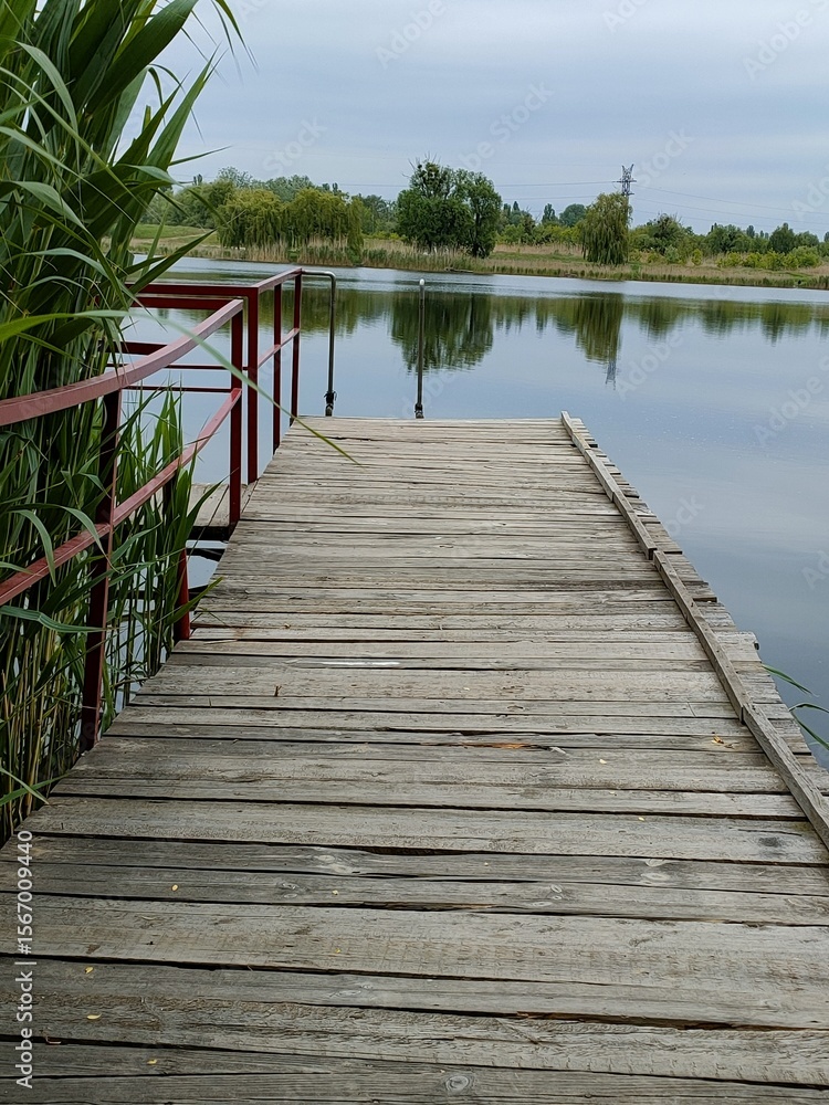 Naklejka premium wooden bridge over the lake