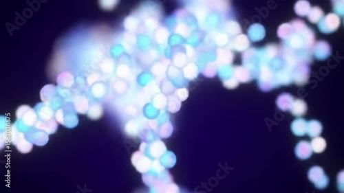 Abstract blue and pink bokeh particles flowing on a dark background animation