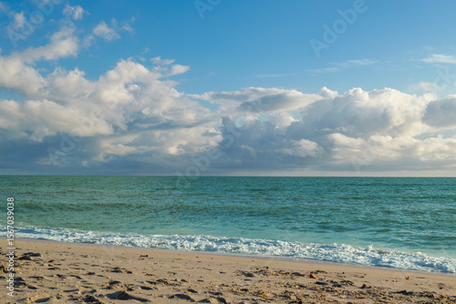 Sandy beach in Nokomis Florida with turquoise Gulf of Mexico under bright cloud sky. High quality photo