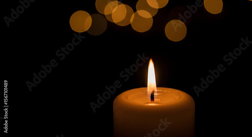 burning candle on a dark background