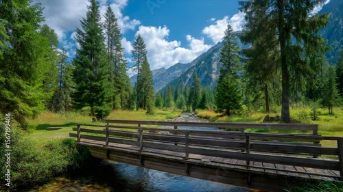 Wallpaper Mural A wooden bridge spans the stream in an alpine forest, surrounded by pine trees and mountains Torontodigital.ca