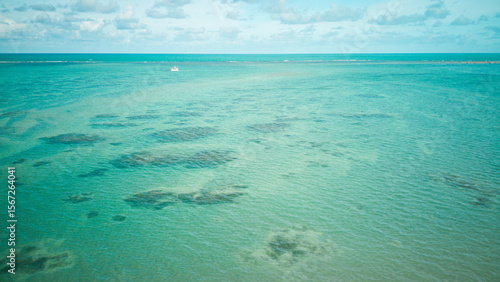 Drone photo of clear turquoise ocean and coral patches off the coast of Cabedelo, Paraíba, northeastern Brazil.