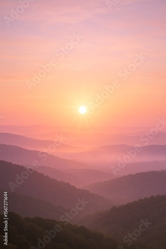 Wallpaper Mural A tranquil sunrise paints soft pastel hues across rolling mist-covered mountains, creating a serene and dreamlike atmosphere.

 Torontodigital.ca