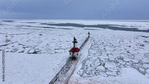 Lighthouse frozen Lake Michigan drone view