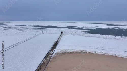 Lighthouse frozen Lake Michigan drone view