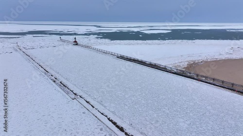 Lighthouse frozen Lake Michigan drone view
