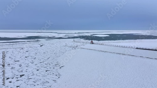 Lighthouse frozen Lake Michigan drone view