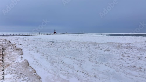 Lighthouse frozen Lake Michigan drone view