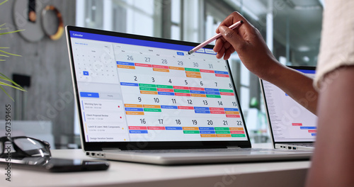 Fotografija Busy African American Woman Managing Corporate Calendar
