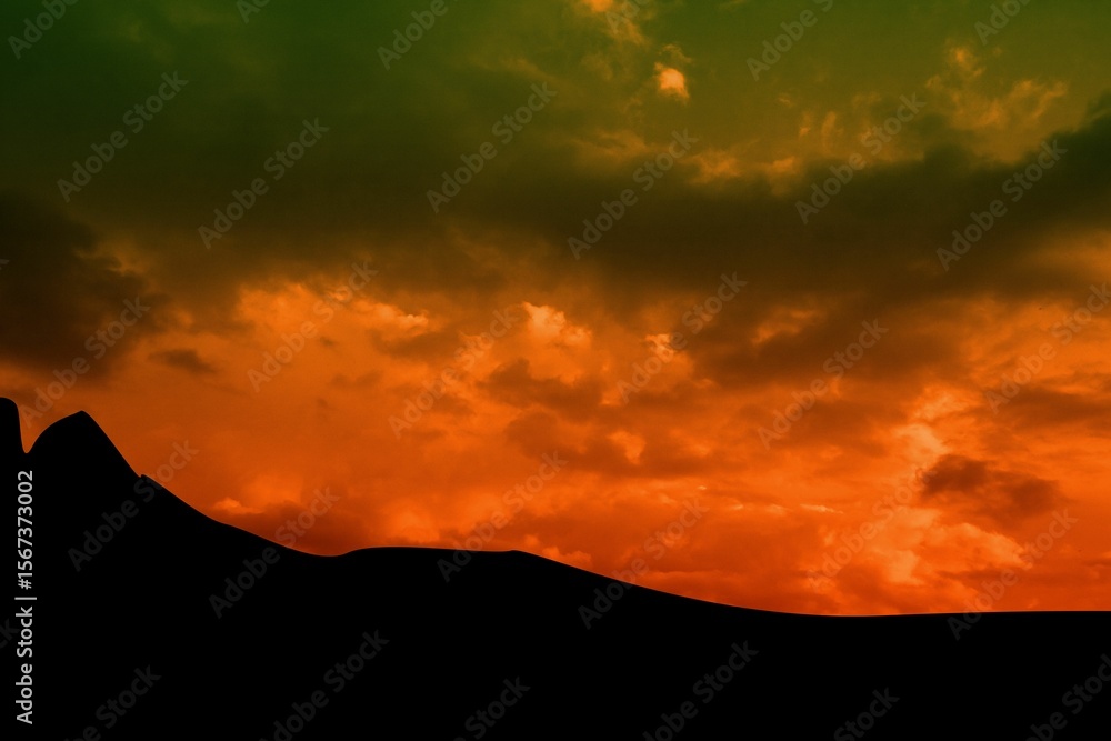 Obraz premium Flat design illustration showing dark dune silhouette under vibrant orange and green sunset clouds