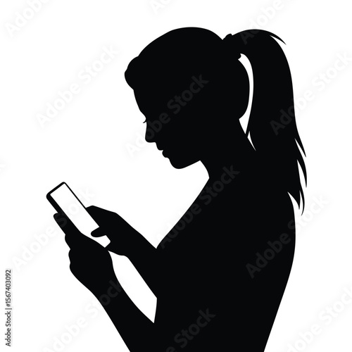 Silhouette of a young woman with a ponytail holding and looking at her smartphone