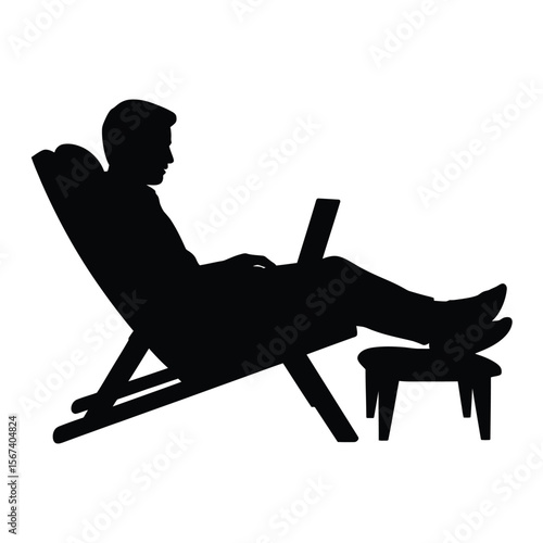 Silhouette of a man relaxing in a deck chair using a laptop computer