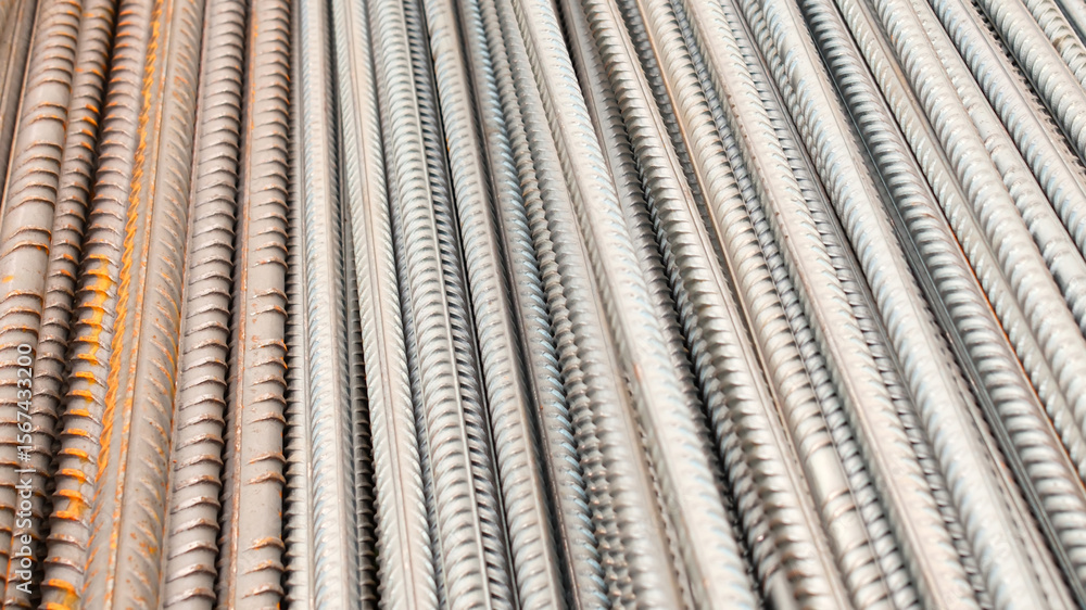 Steel reinforcement for concrete reinforcement. Pile of steel rebars stacked on a construction site Steel reinforcement for concrete reinforcement. Pile of steel rebars stacked on a construction site
