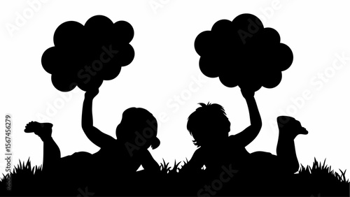 Silhouette of two children lying in grass holding cloud shapes in the air on a white background