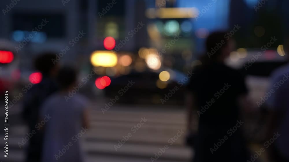 blurred view of pedestrian waiting to cross the street at night blurred view of pedestrian waiting to cross the street at night
