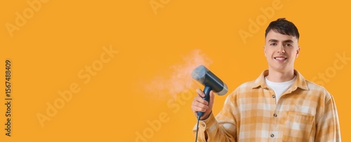 Young man with steamer for ...