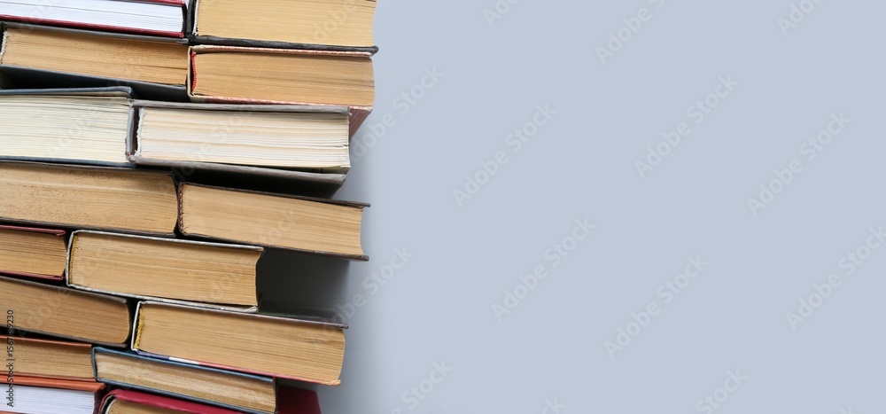 Many books on grey background with space for text, top view Many books on grey background with space for text, top view