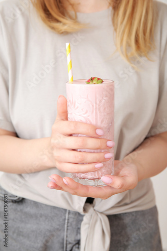 Woman holding glass of tast...