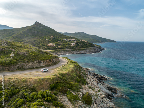 Aerial view car Roadtrip Winding road along rocky coast of Cap Corse peninsula on Corsica island France