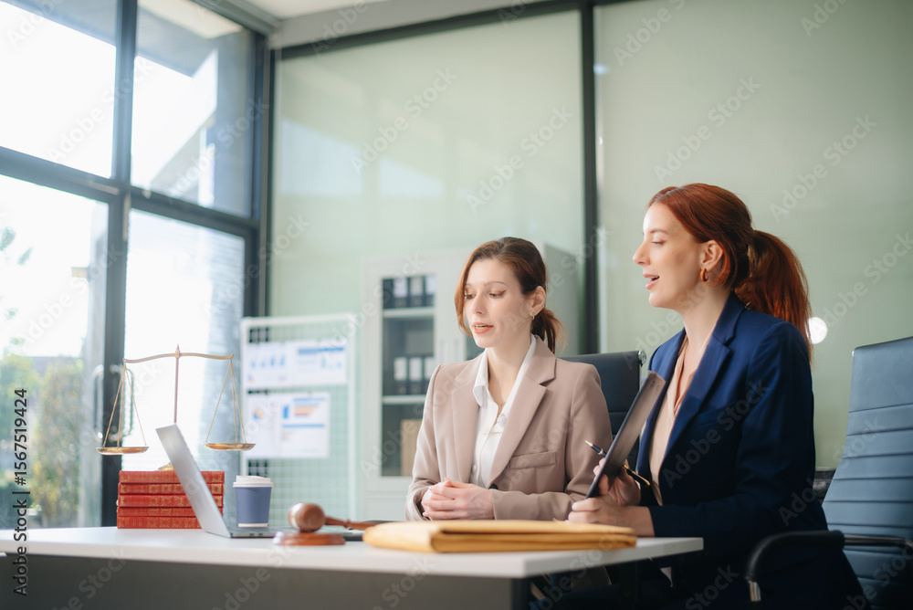 Obraz premium Professional female lawyers consulting on legal cases in a modern office. Perfect for law, business, justice