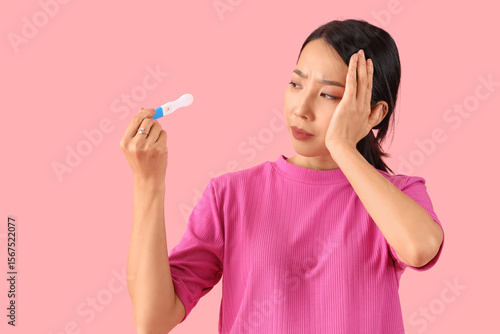 Upset Asian woman with preg...