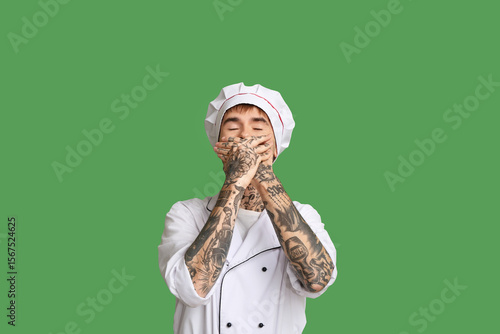 Laughing young chef on gree...