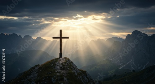 Cross on mountaintop, sunbeams