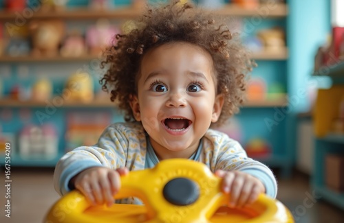 Ecstatic toddler grips bright yellow toy steering wheel, eyes wide with wonder in vibrant, colorful store setting. Child beams with pure joy and excitement, engaged in imaginative play and discovery.