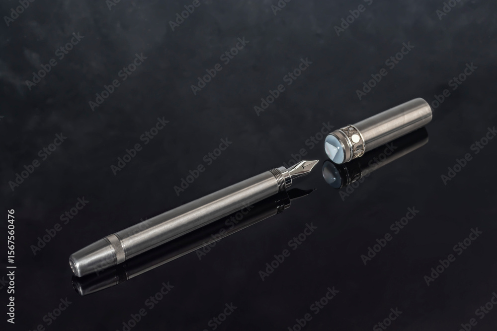 Fototapeta premium Fountain pen with box on dark gray background. Stationery branded items