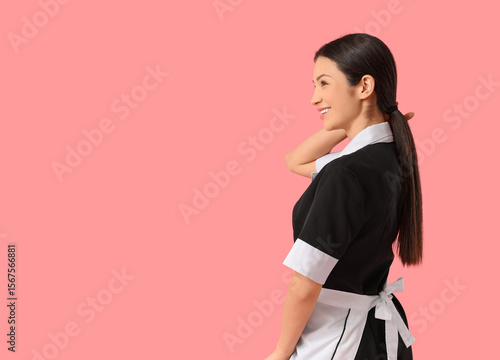 Young chambermaid on pink b...