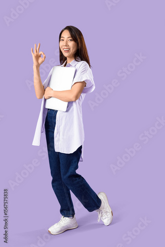 Young Asian woman with lapt...