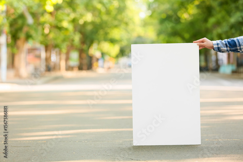 Female hand holding blank p...