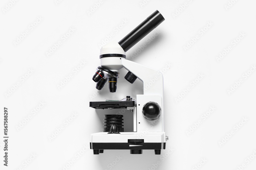 Fototapeta premium Modern microscope on white background, top view